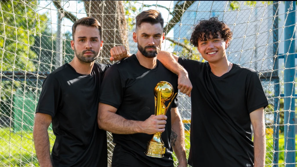 Three athletes posing together with a trophy after a sports event, captured for event photography coverage