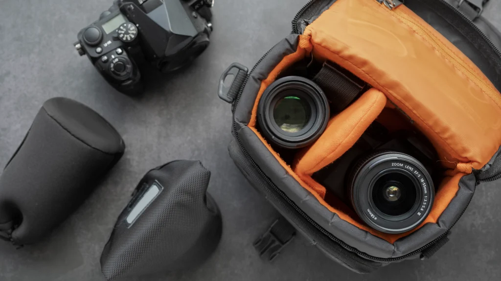 Camera, lenses, and gear packed in a padded equipment bag for product photography