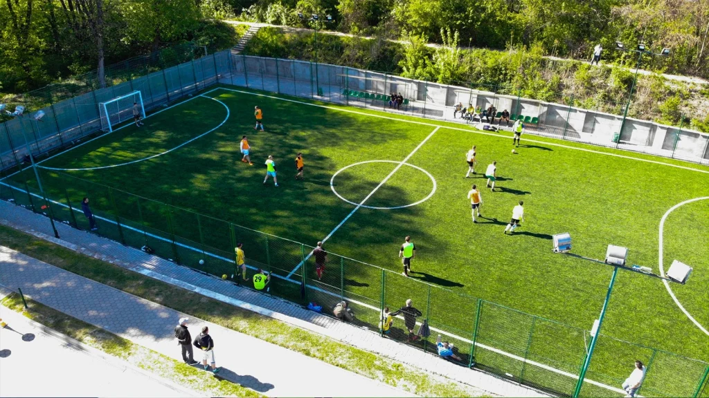 Aerial drone view of a soccer match in progress, showcasing a trending high-angle sports photography perspective