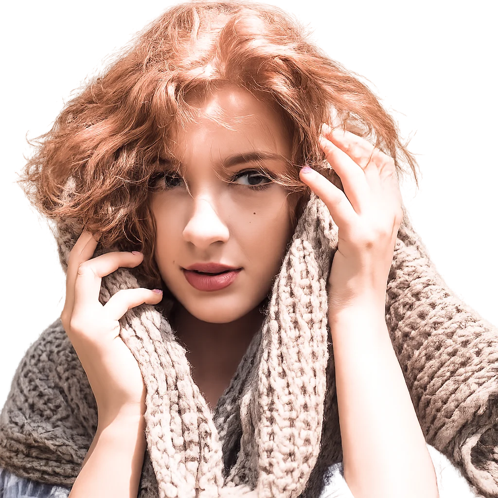 A red-haired woman wrapped in a thick knitted scarf is isolated on a transparent background.