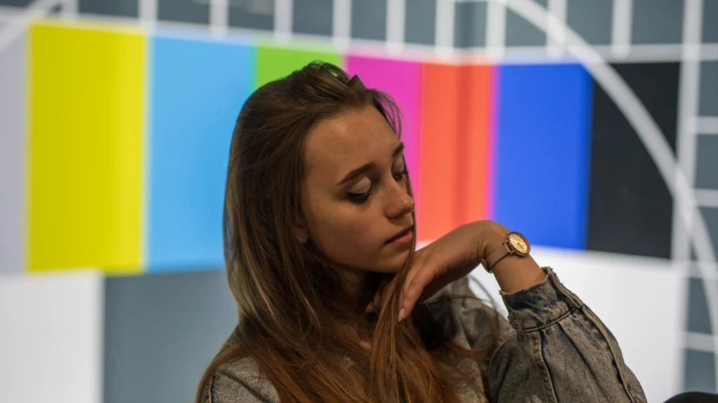 Portrait against color bars illustrating common color grading mistakes like oversaturation and uncalibrated displays