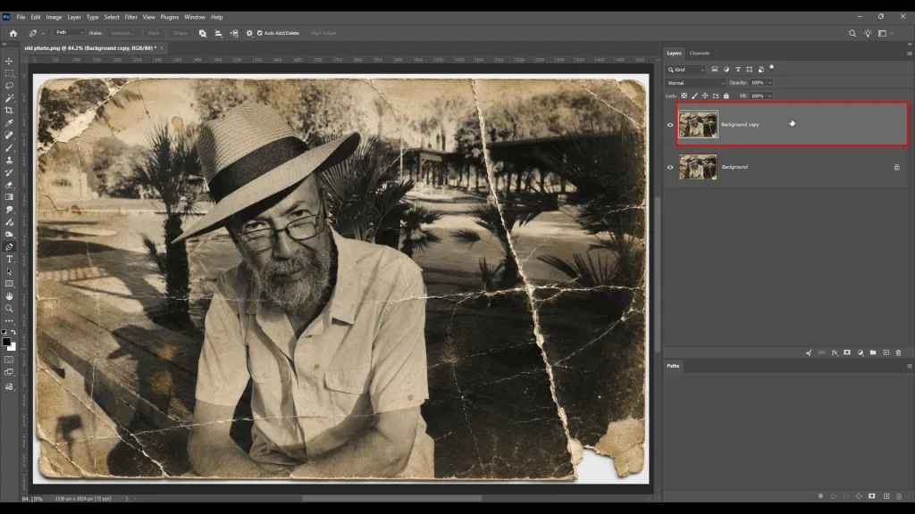 Duplicating and locking the original background layer in Photoshop for non-destructive photo restoration
