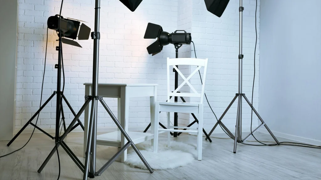 Professional fashion photography studio with lights, stands, chair and backdrop