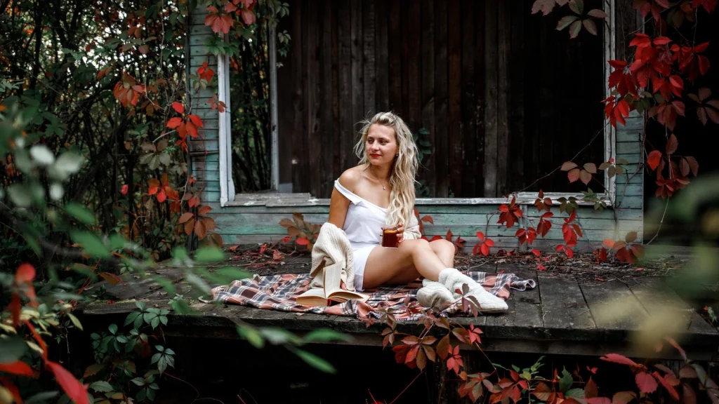 Fashion model posing outdoors among colorful autumn leaves for seasonal storytelling
