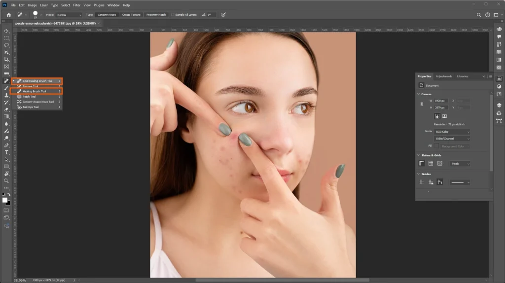 Photoshop Spot Healing Brush and Healing Brush tools displayed for removing facial blemishes