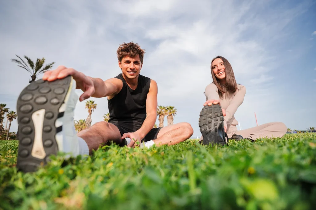 photography-common-mistakes-stretching.webp Couple stretching outdoors on grass, used to illustrate common lifestyle brand photography mistakes
