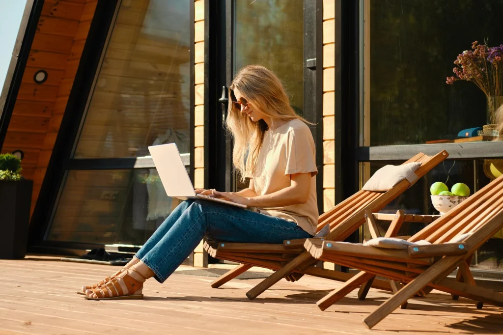 Woman working on a laptop in a deck chair, illustrating composition principles in lifestyle product photography