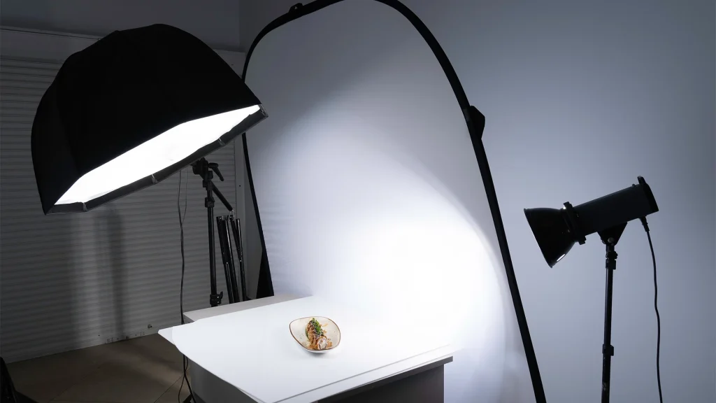 Food product photography lighting setup comparing softbox and spotlight sources for consistent results