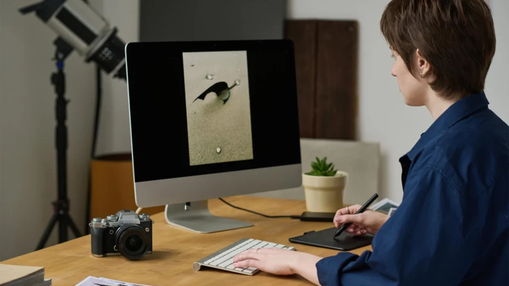 Photo editor reviewing an image on screen as part of a consistent editing and quality control workflow