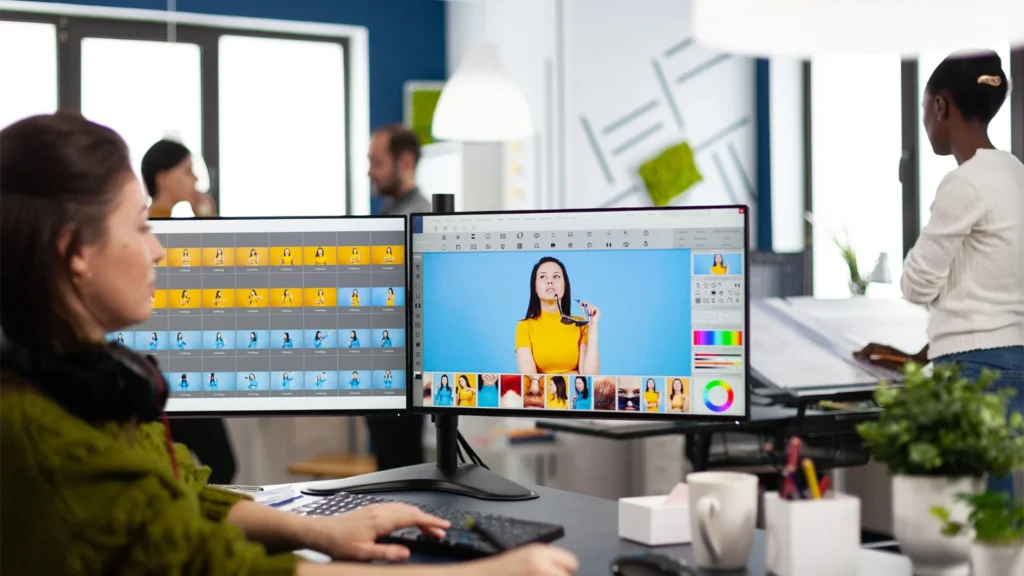In-house photo editor retouching a portrait against a blue backdrop, showing the true cost of in-house editing