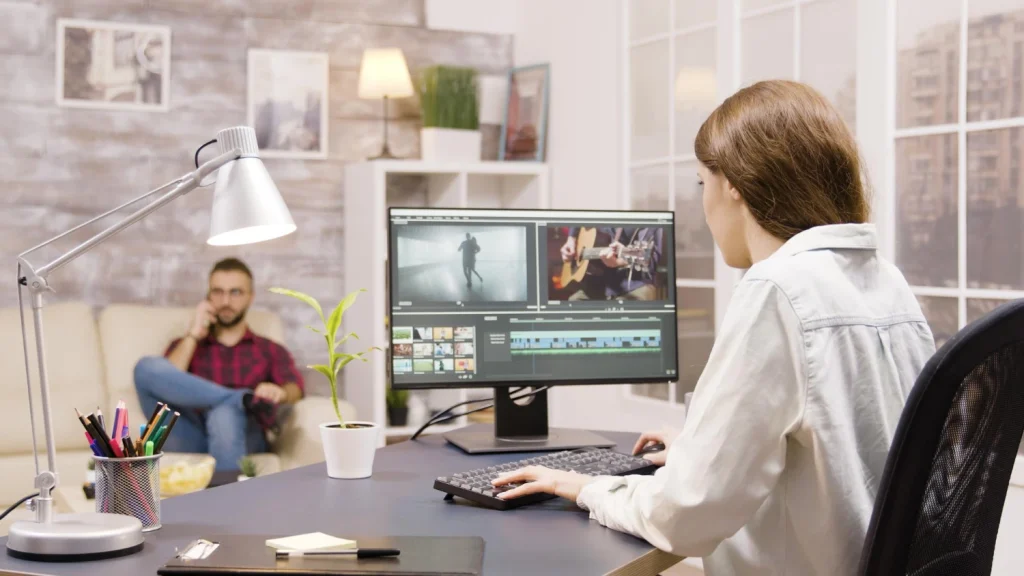 Video editor reviewing footage while weighing in-house vs outsourced image editing options