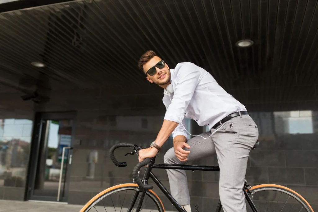 Man in business casual attire riding a bicycle outdoors, demonstrating lifestyle product photography in action