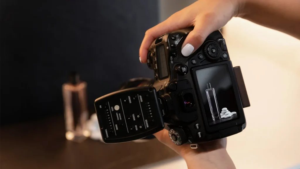 Photographer adjusting a professional camera to capture detailed product images