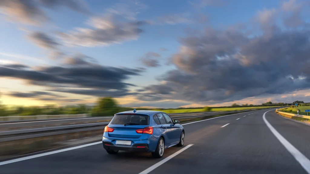 Car photography on a city highway with dramatic evening skies
