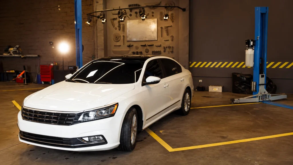 White car photographed inside an industrial warehouse for car photography