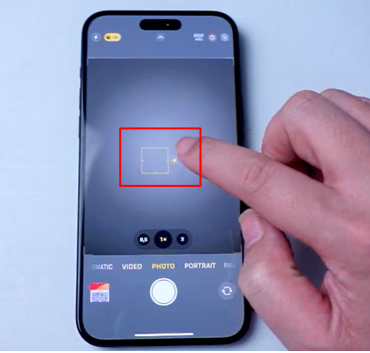iPhone camera exposure compensation setting for sports photography, adjusting brightness by tapping the subject and sliding the exposure control.