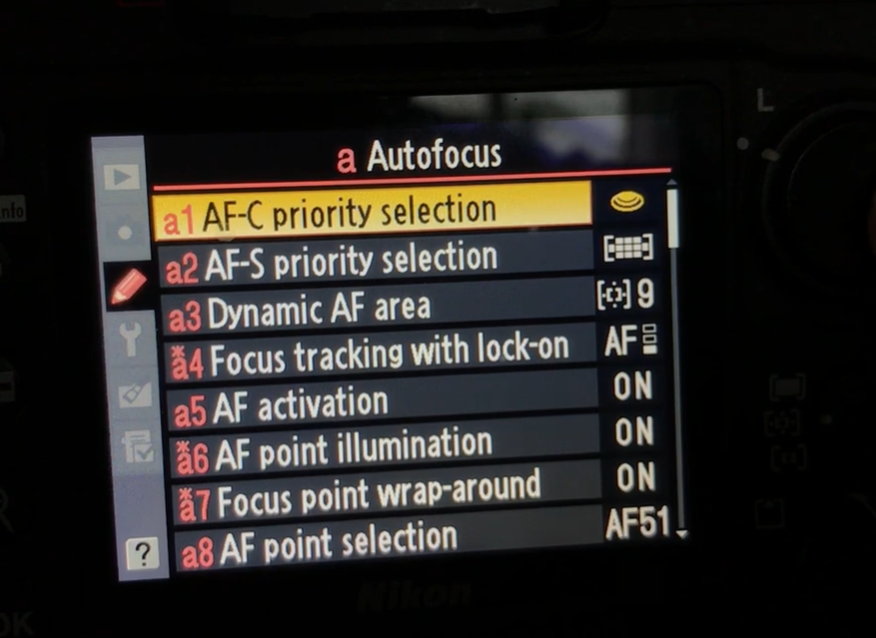 Nikon autofocus settings for sports photography showing AF-C priority selection, Dynamic-Area AF, focus tracking, and AF point illumination.