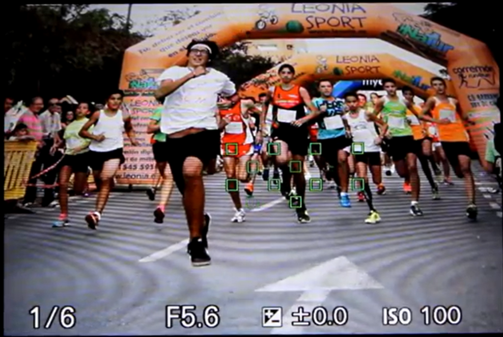 Sony A6000 running photography settings showing aperture priority mode, f/5.6 aperture, ISO 100, and continuous shooting.