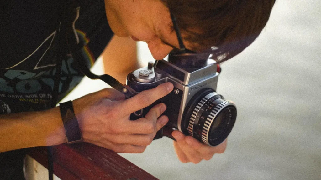 Photographer adjusting and securing a camera before starting a product photography batch