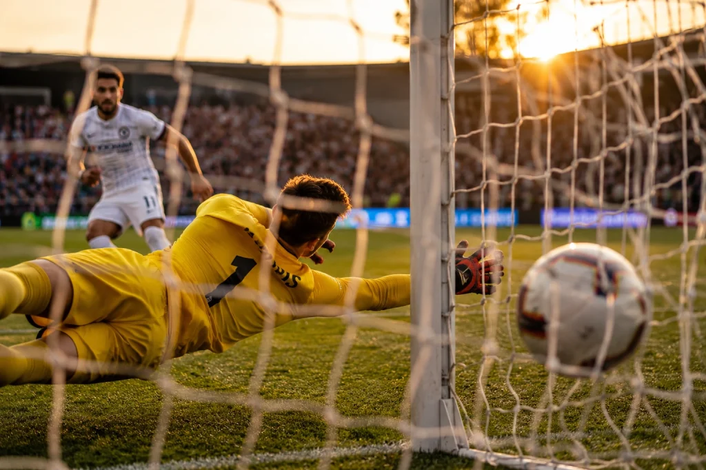 Football player taking a penalty kick from a prime scoring position for dynamic sports photography.