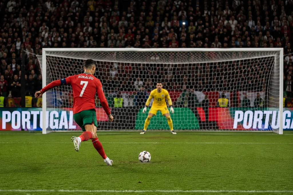 Soccer player celebrating after scoring a goal, illustrating impactful sports photo editing techniques.