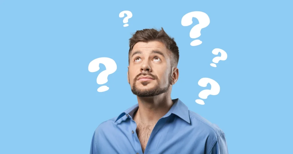Man surrounded by question marks thinking about whether video editing is the right career choice
