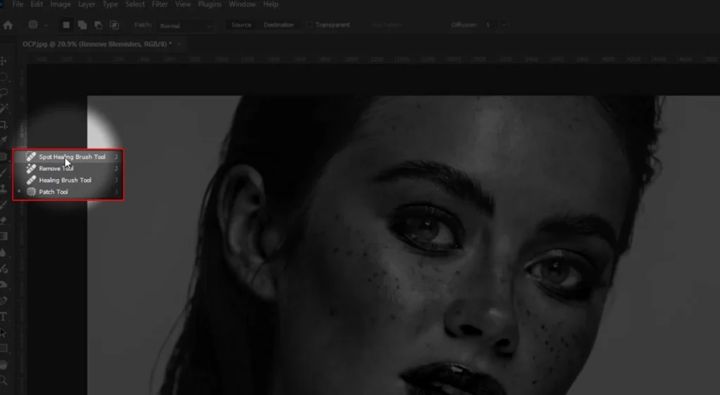 Photoshop toolbar showing the Spot Healing Brush, Healing Brush and Patch tools for removing skin blemishes