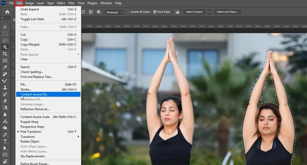 Object Selection tool drawing a selection around a person to remove with Content-Aware Fill in Photoshop