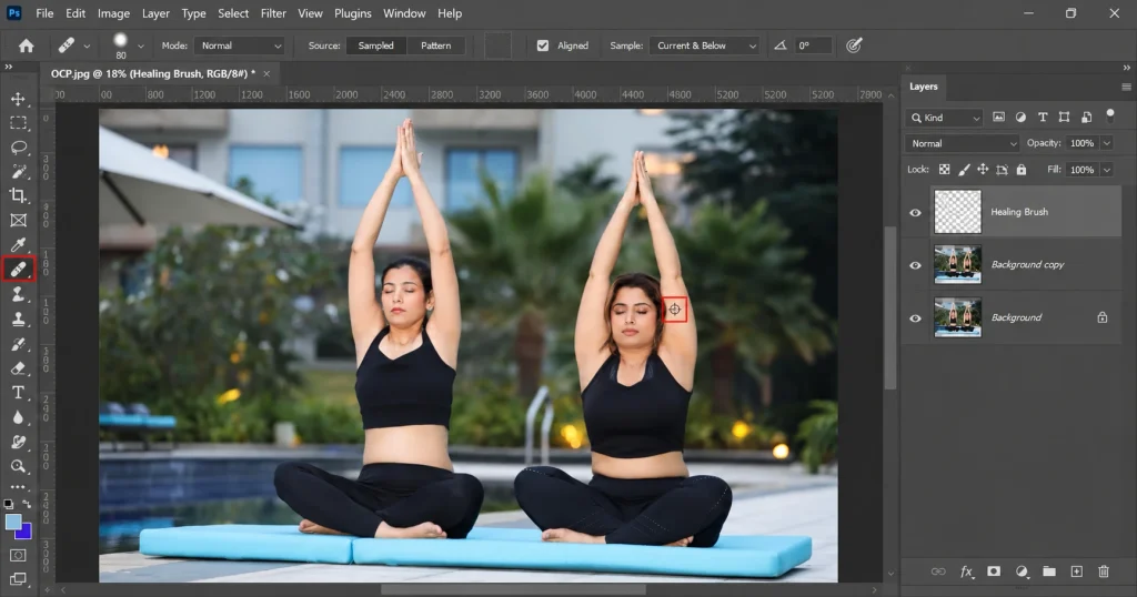 Photoshop Healing Brush with the Alt-click source point marked by a crosshair